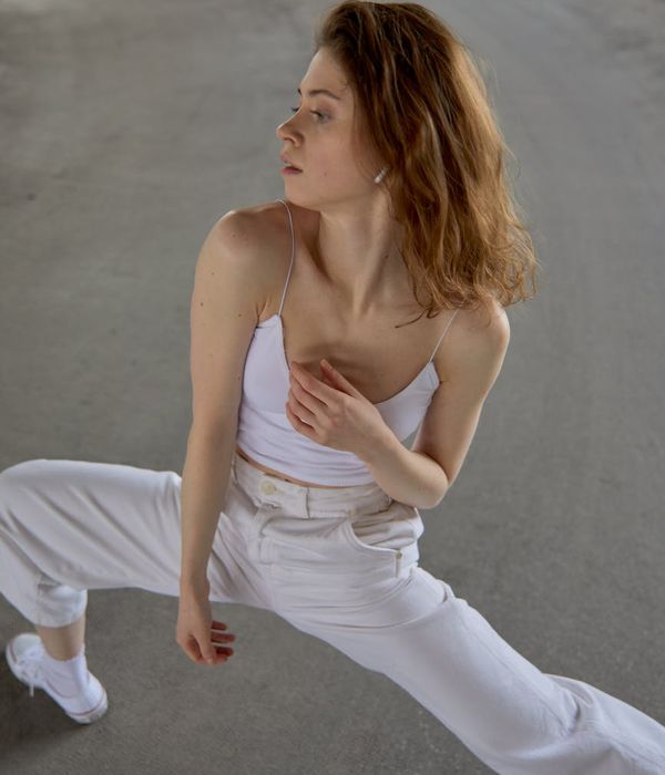 Woman performing a graceful yoga flow in a calm setting.